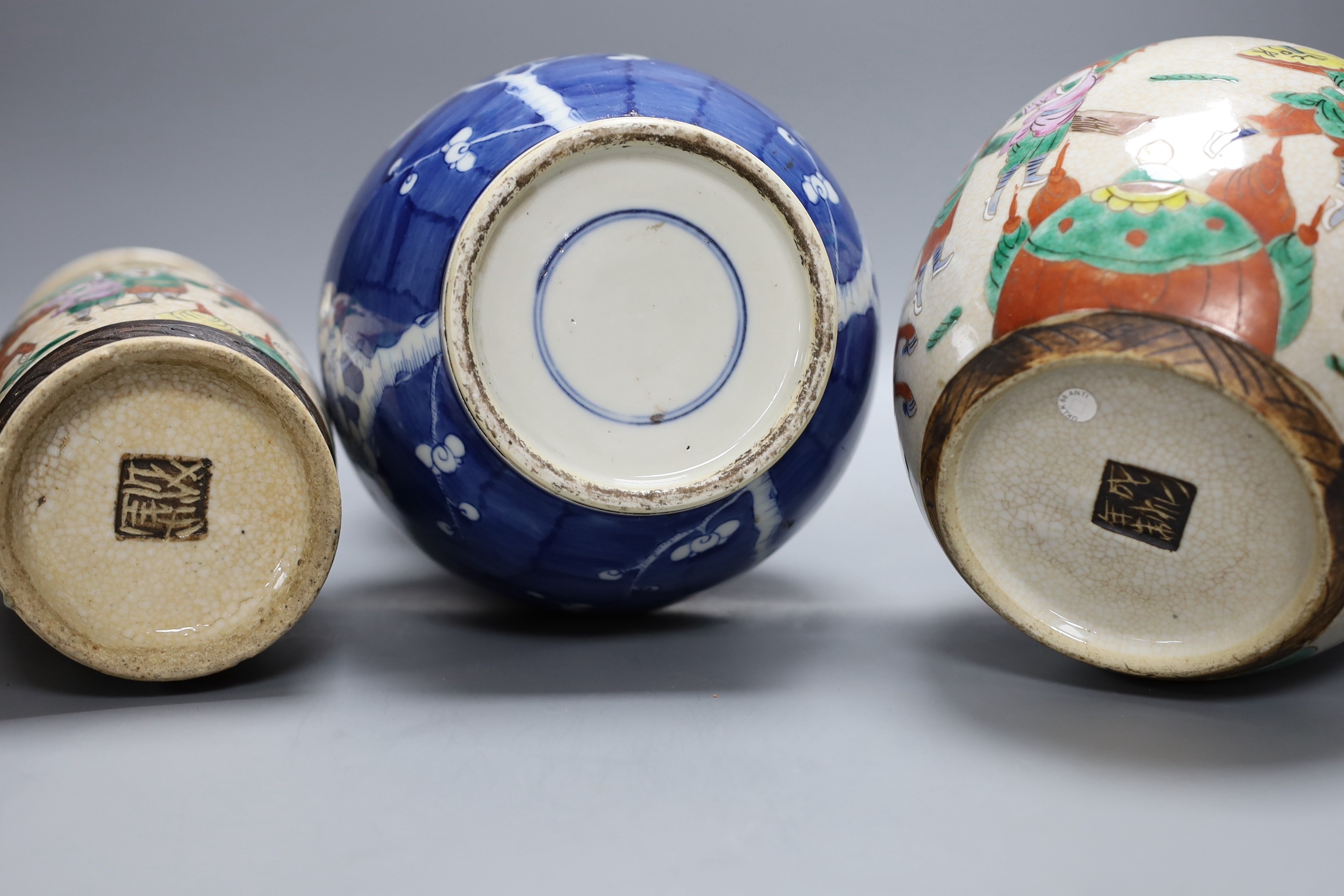 A Chinese crackle glaze vase and jar and a blue with figural decoration, together with a Chinese blue and white prunus double gourd vase, tallest 37cm
